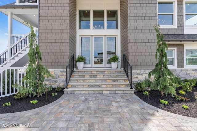 entrance to property featuring stone siding