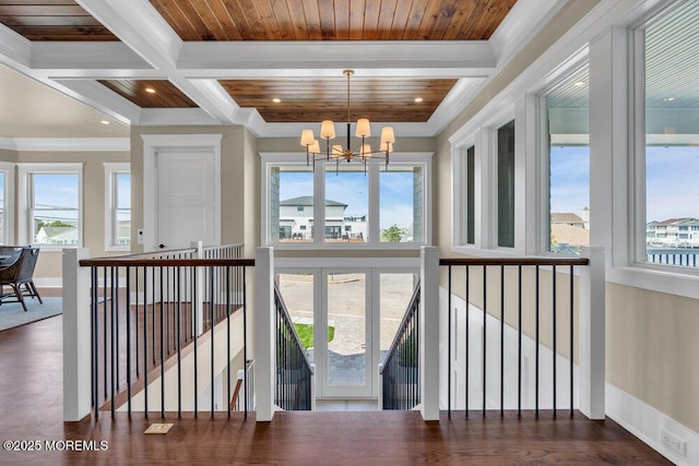 interior space featuring crown molding, baseboards, beamed ceiling, a chandelier, and coffered ceiling