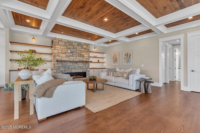 living area with coffered ceiling, wood finished floors, a fireplace, and beamed ceiling