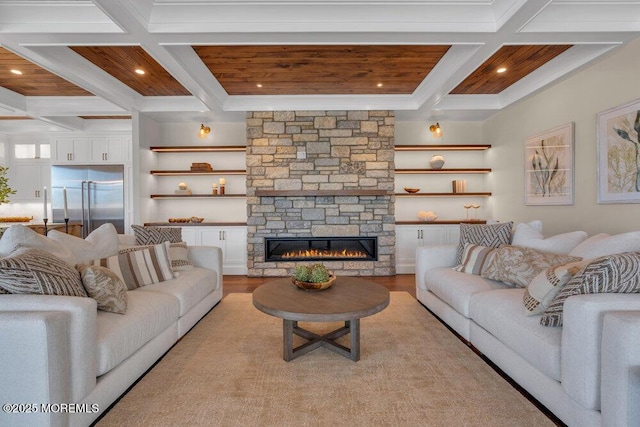 living area featuring recessed lighting, a stone fireplace, beam ceiling, and coffered ceiling