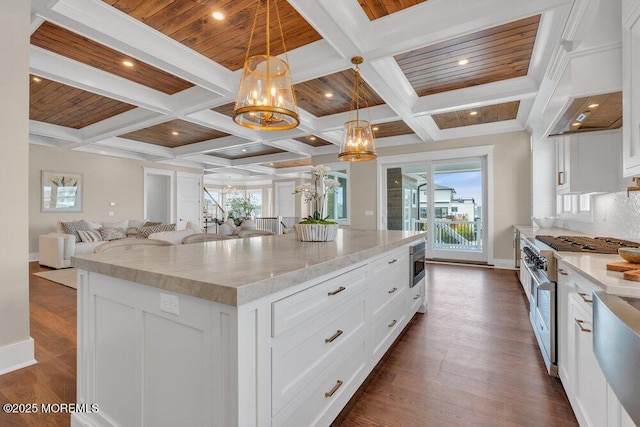 kitchen with a chandelier, appliances with stainless steel finishes, open floor plan, coffered ceiling, and a wealth of natural light