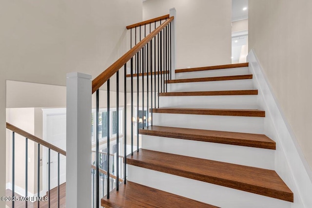 stairway with wood finished floors
