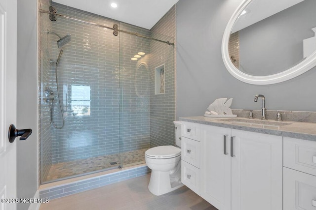 full bathroom with vanity, recessed lighting, a stall shower, and toilet