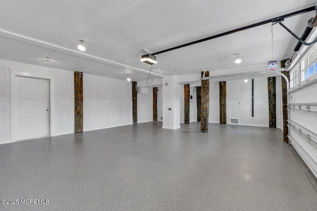 garage with visible vents and a garage door opener