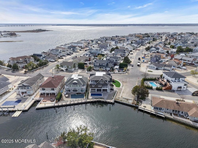 drone / aerial view with a water view and a residential view