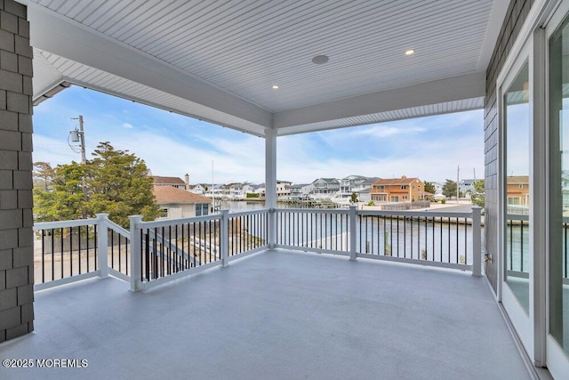 view of patio with a residential view and a water view