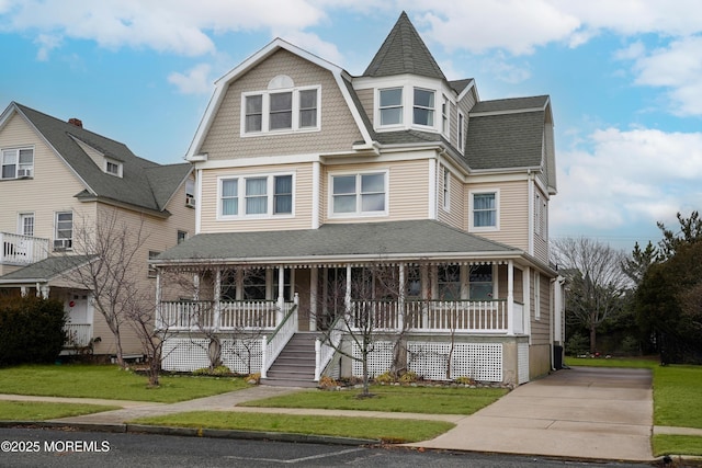 victorian home with a porch and a front yard