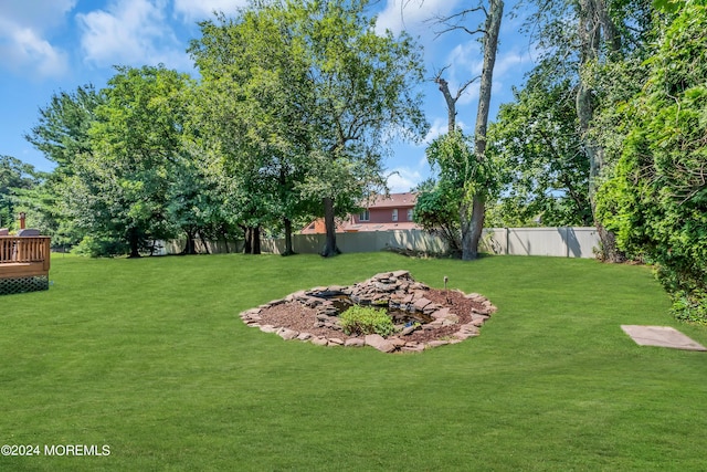 view of yard with a wooden deck