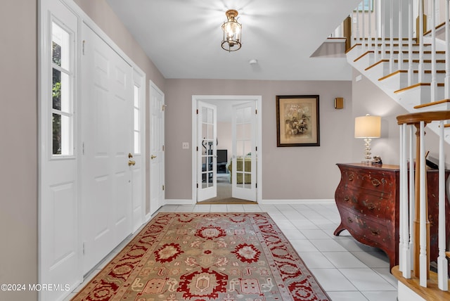 foyer entrance featuring light tile patterned floors and french doors