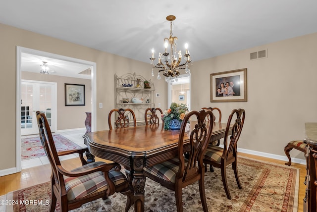 dining space featuring a chandelier and light wood-type flooring