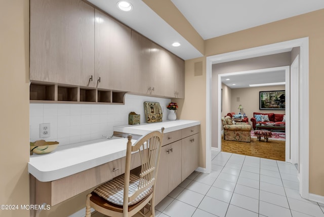 kitchen featuring light tile patterned floors, backsplash, and light brown cabinetry