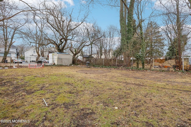 view of yard with a storage shed and fence