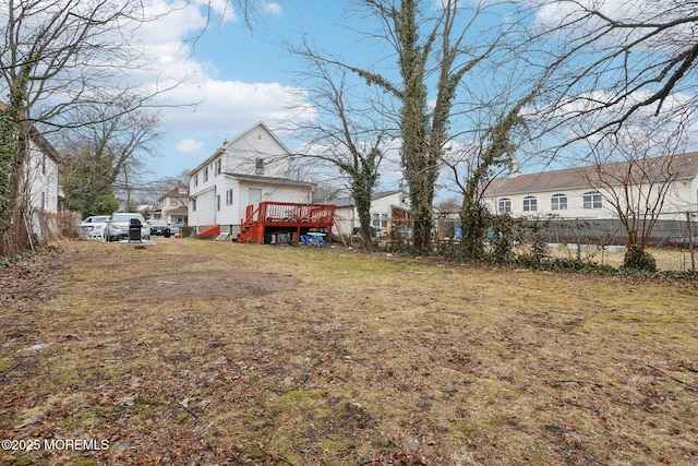 view of yard with fence and a wooden deck
