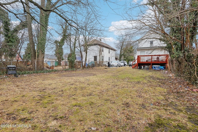 view of yard featuring fence and a wooden deck