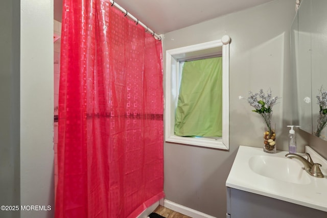 bathroom with vanity and baseboards