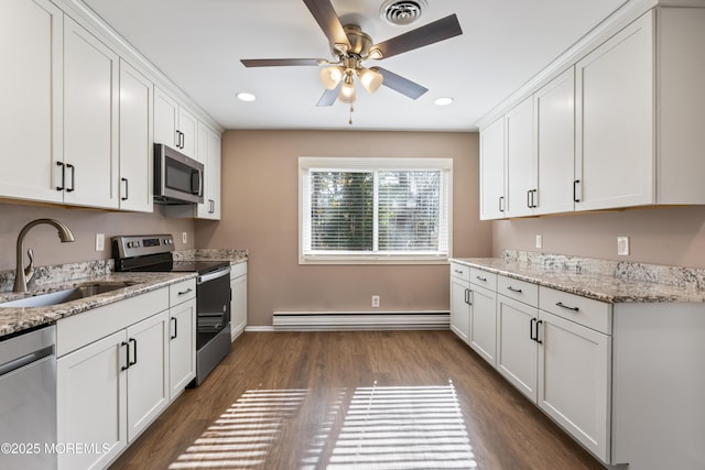 kitchen featuring a baseboard heating unit, a sink, visible vents, appliances with stainless steel finishes, and dark wood-style floors