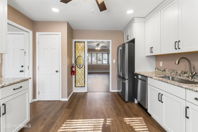 kitchen featuring light stone counters, stainless steel appliances, sink, and white cabinets