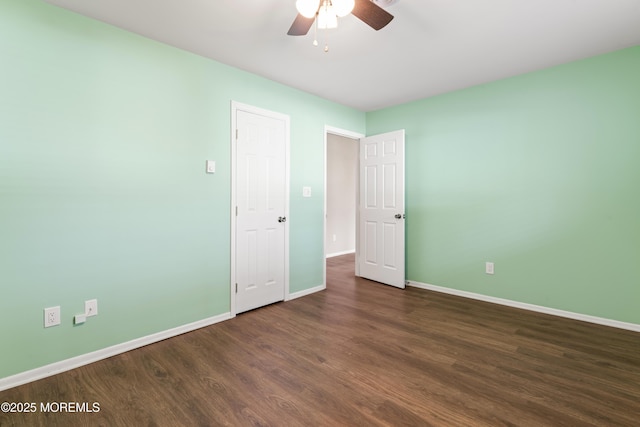 unfurnished bedroom with ceiling fan and dark hardwood / wood-style floors