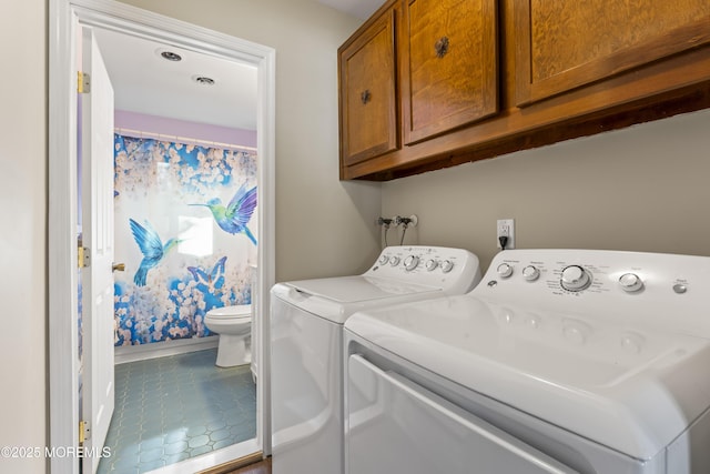 washroom with tile patterned floors and washing machine and dryer