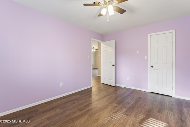 spare room featuring dark hardwood / wood-style flooring and ceiling fan