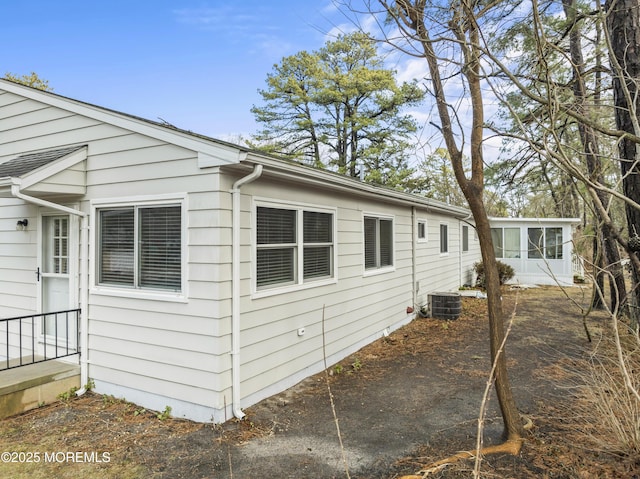 view of side of home featuring central air condition unit