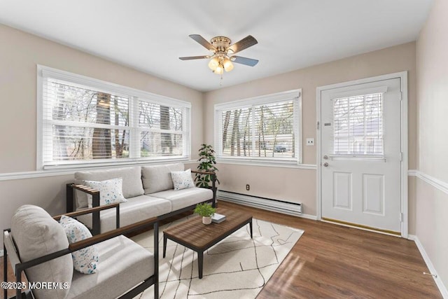 living room with hardwood / wood-style flooring, a baseboard radiator, and ceiling fan