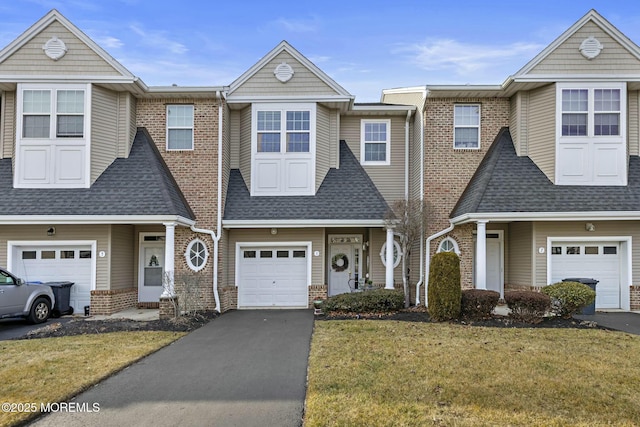 multi unit property featuring a garage and a front yard