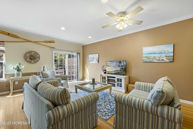 living room with crown molding, ceiling fan, and light hardwood / wood-style floors