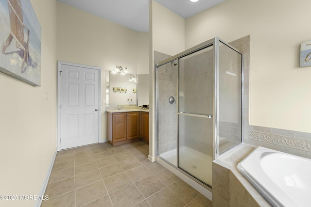 bathroom featuring vanity, plus walk in shower, and tile patterned flooring