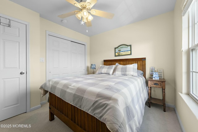 carpeted bedroom with ceiling fan and a closet