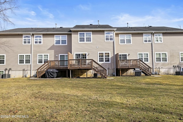 back of property featuring a yard, a deck, and central air condition unit