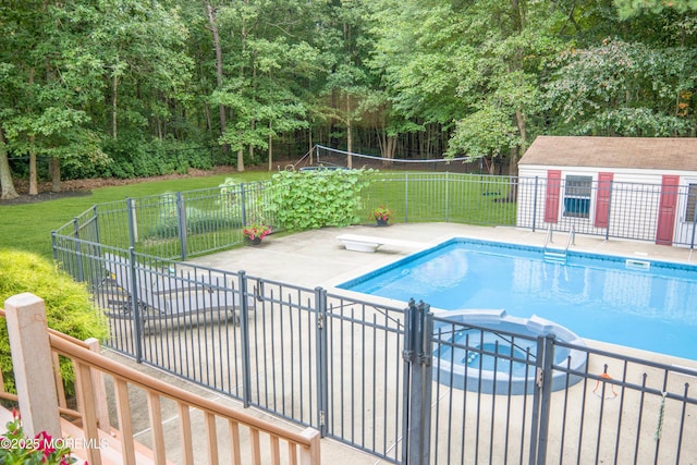 view of pool with a patio, a diving board, and a yard