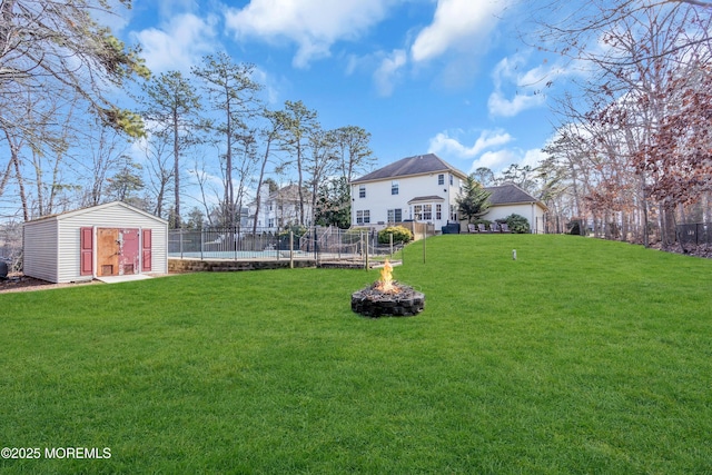 view of yard featuring a storage shed and a fire pit