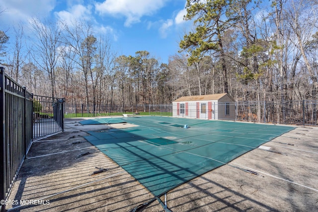 view of pool featuring an outbuilding and a patio area