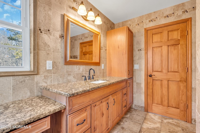 bathroom featuring decorative backsplash, vanity, and tile walls