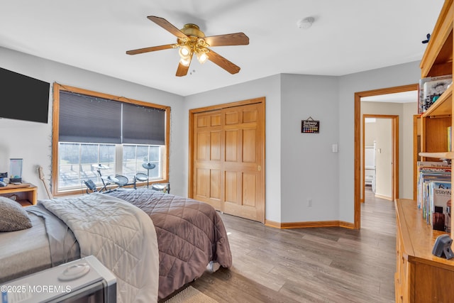 bedroom featuring wood-type flooring, a closet, and ceiling fan