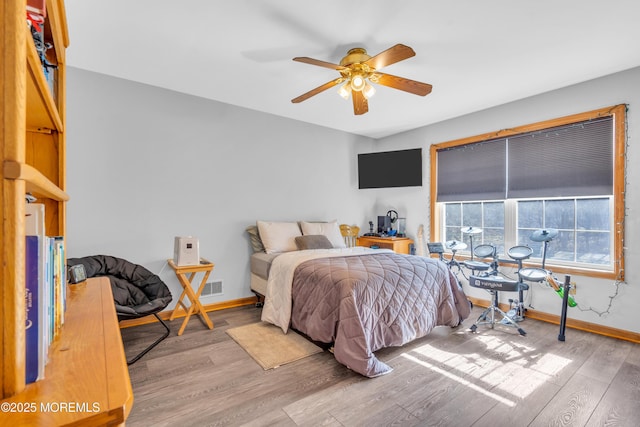 bedroom with ceiling fan and light wood-type flooring