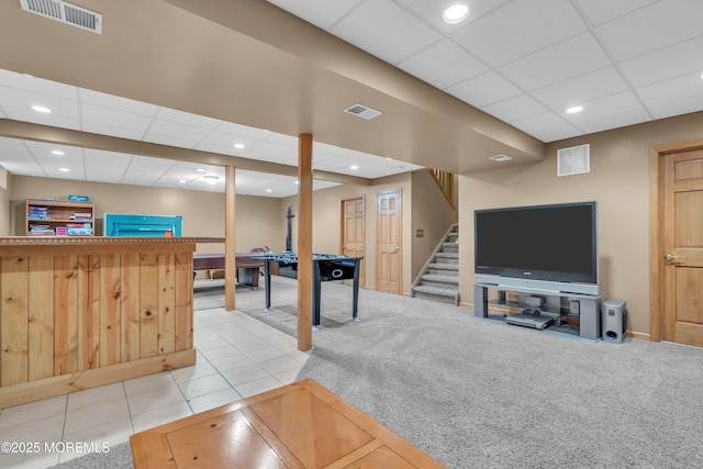 interior space featuring carpet floors and a drop ceiling