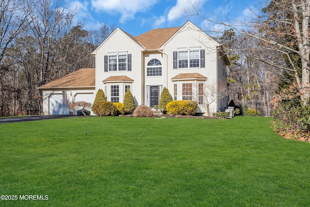 view of front facade with a garage and a front yard