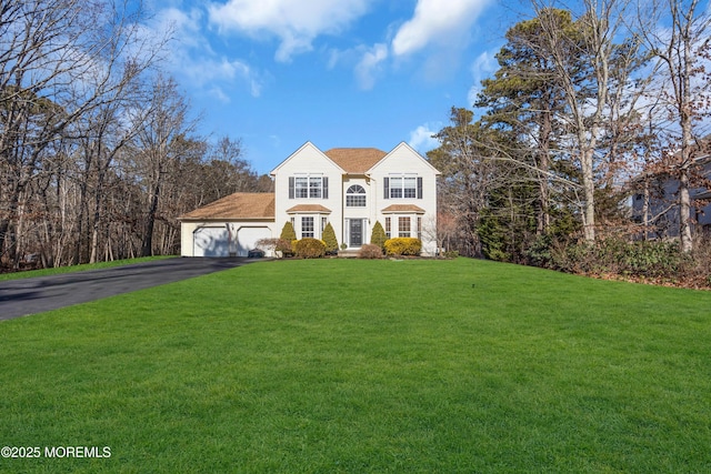 view of front of home featuring a garage and a front yard