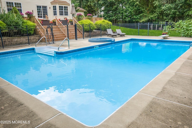 view of swimming pool featuring an in ground hot tub and a diving board