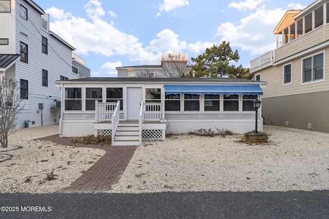 view of front of property with a sunroom