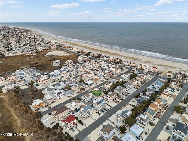 birds eye view of property with a view of the beach and a water view