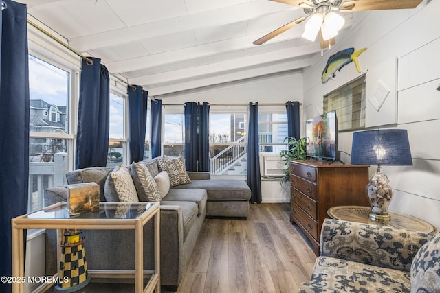 living room with lofted ceiling with beams, light hardwood / wood-style floors, and ceiling fan