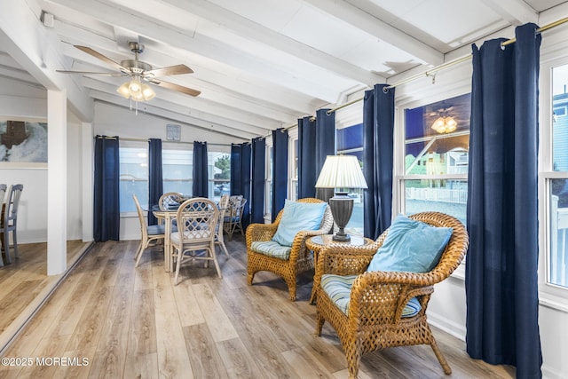 sunroom with ceiling fan and lofted ceiling with beams