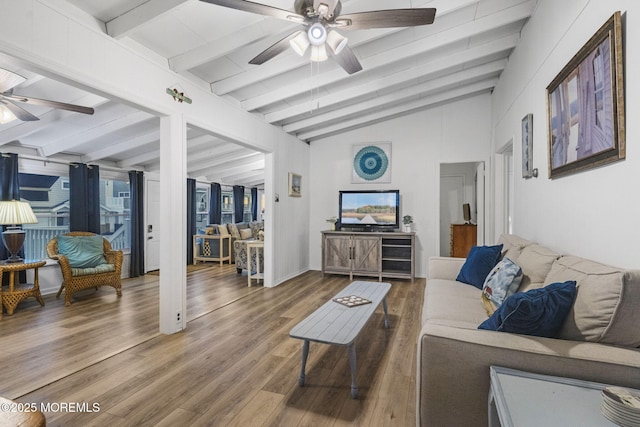 living room with vaulted ceiling with beams, hardwood / wood-style flooring, a wealth of natural light, and ceiling fan