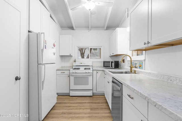 kitchen with sink, white cabinetry, beam ceiling, stainless steel appliances, and light hardwood / wood-style floors