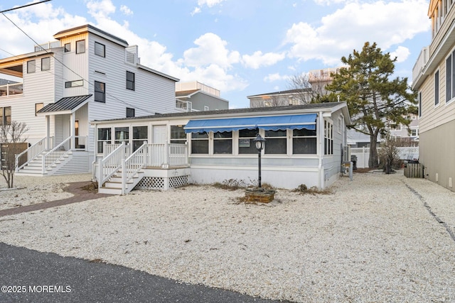 view of front of property featuring a sunroom