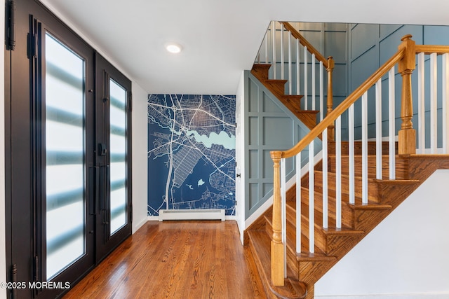 entryway with a baseboard radiator and hardwood / wood-style floors