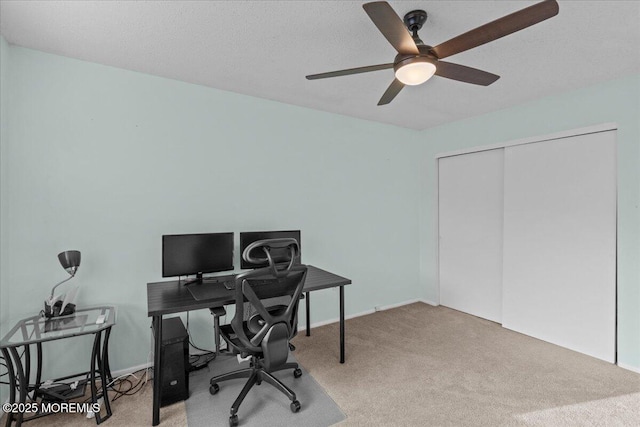 office space featuring a textured ceiling, a ceiling fan, and carpet flooring